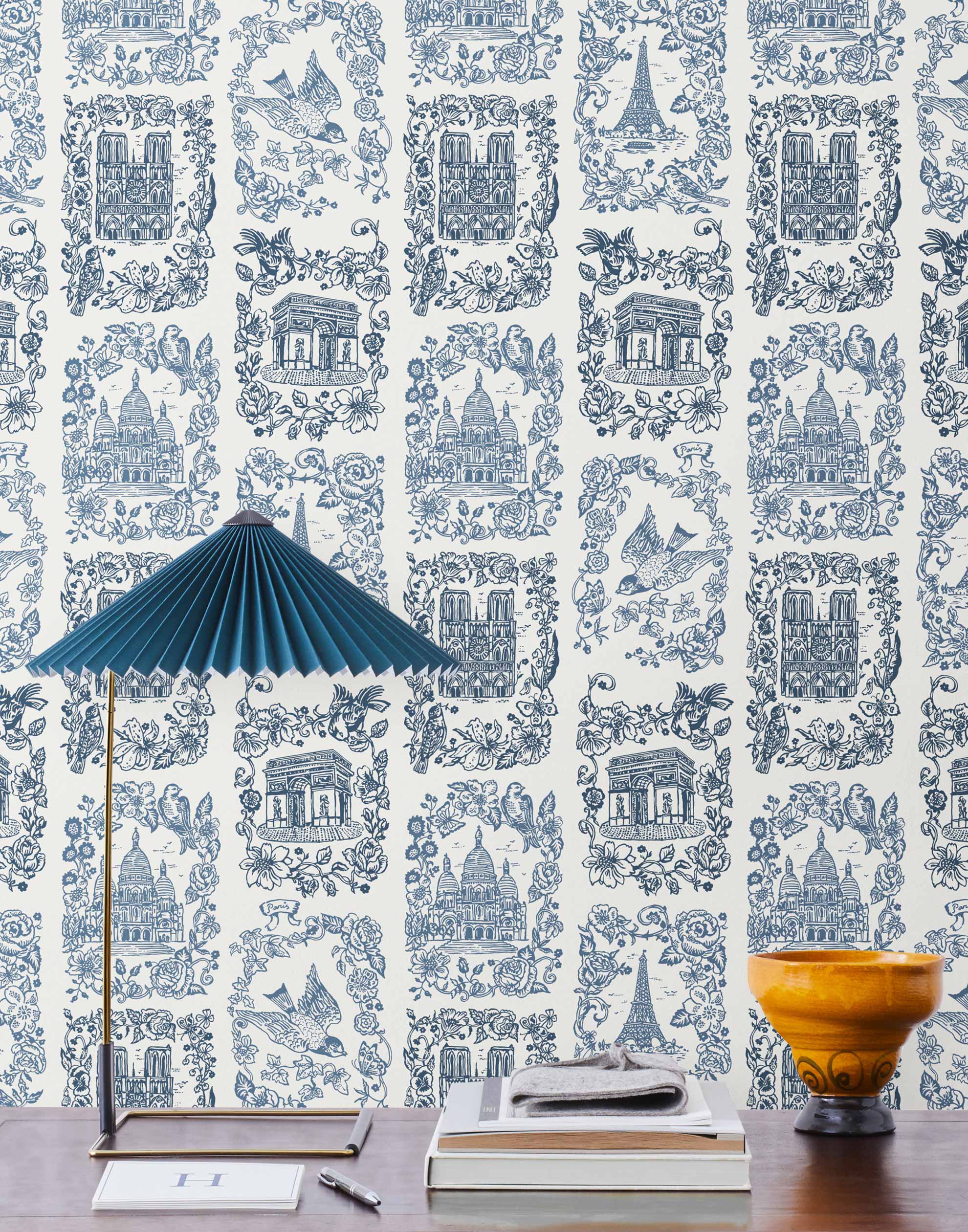 Je T'aime Paris (Porcelain) wallpaper featuring blue illustrations of Paris landmarks on a white background | Nathalie Lete + Hygge & West