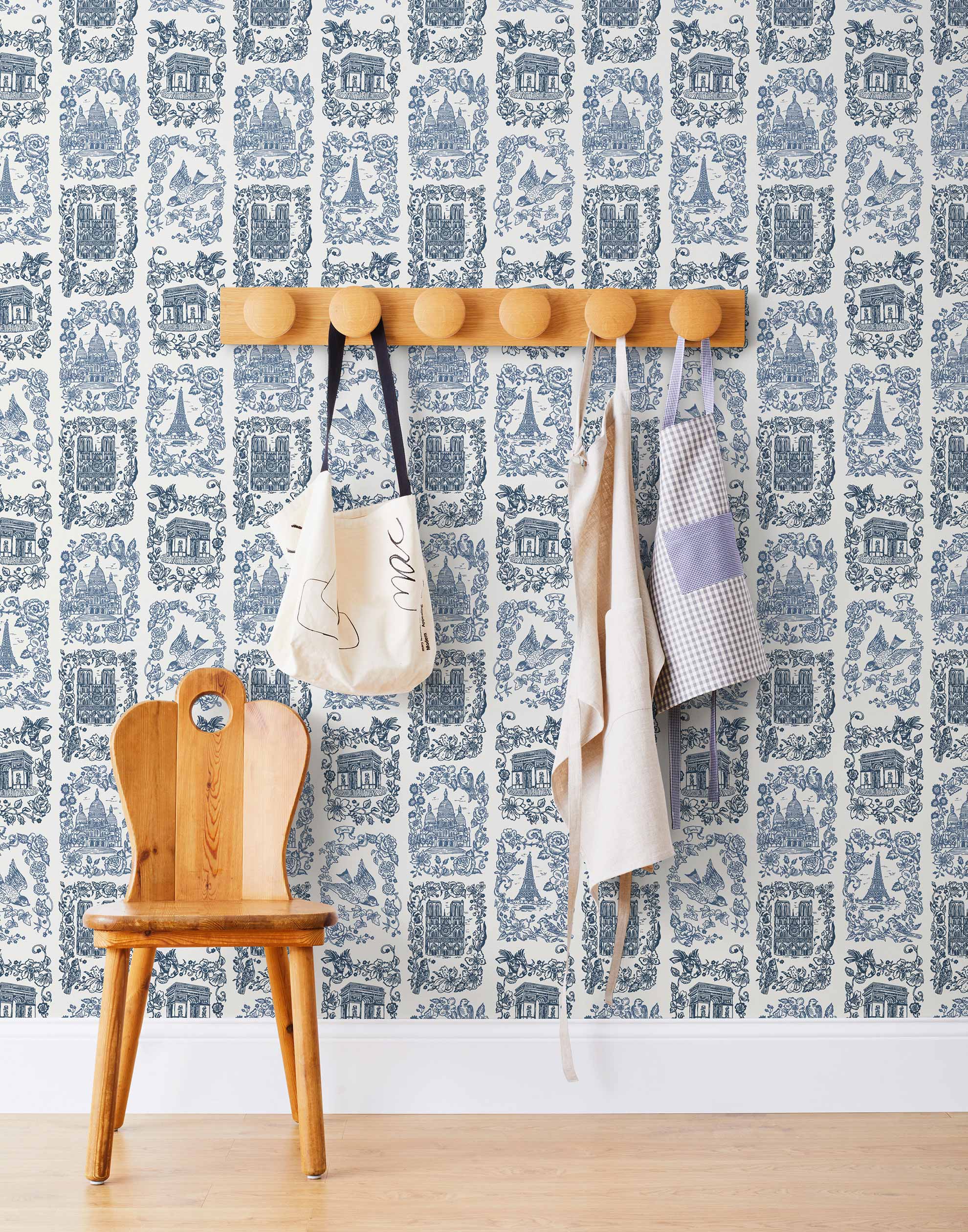Je T'aime Paris (Porcelain) wallpaper featuring blue illustrations of Paris landmarks on a white background | Nathalie Lete + Hygge & West