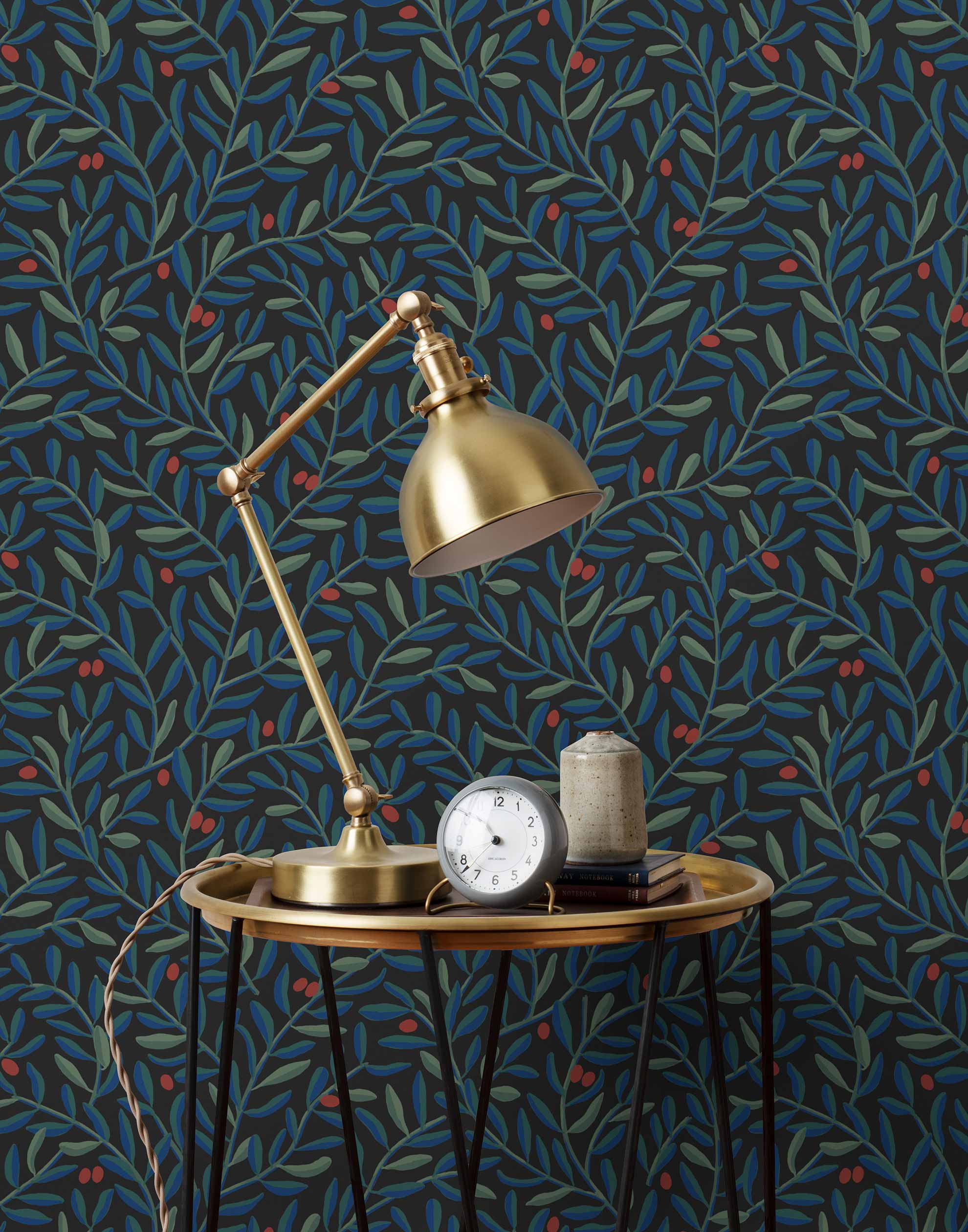 Olive Grove (Ebony) featuring a leafy vine motif in shades of green and blue with deep red accents on a black background | Schoolhouse x Hygge & West Wallpaper Collection