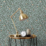 Olive Grove (Mist) featuring a leafy vine motif in shades of green with copper accents on dusty blue background | Schoolhouse x Hygge & West Wallpaper Collection