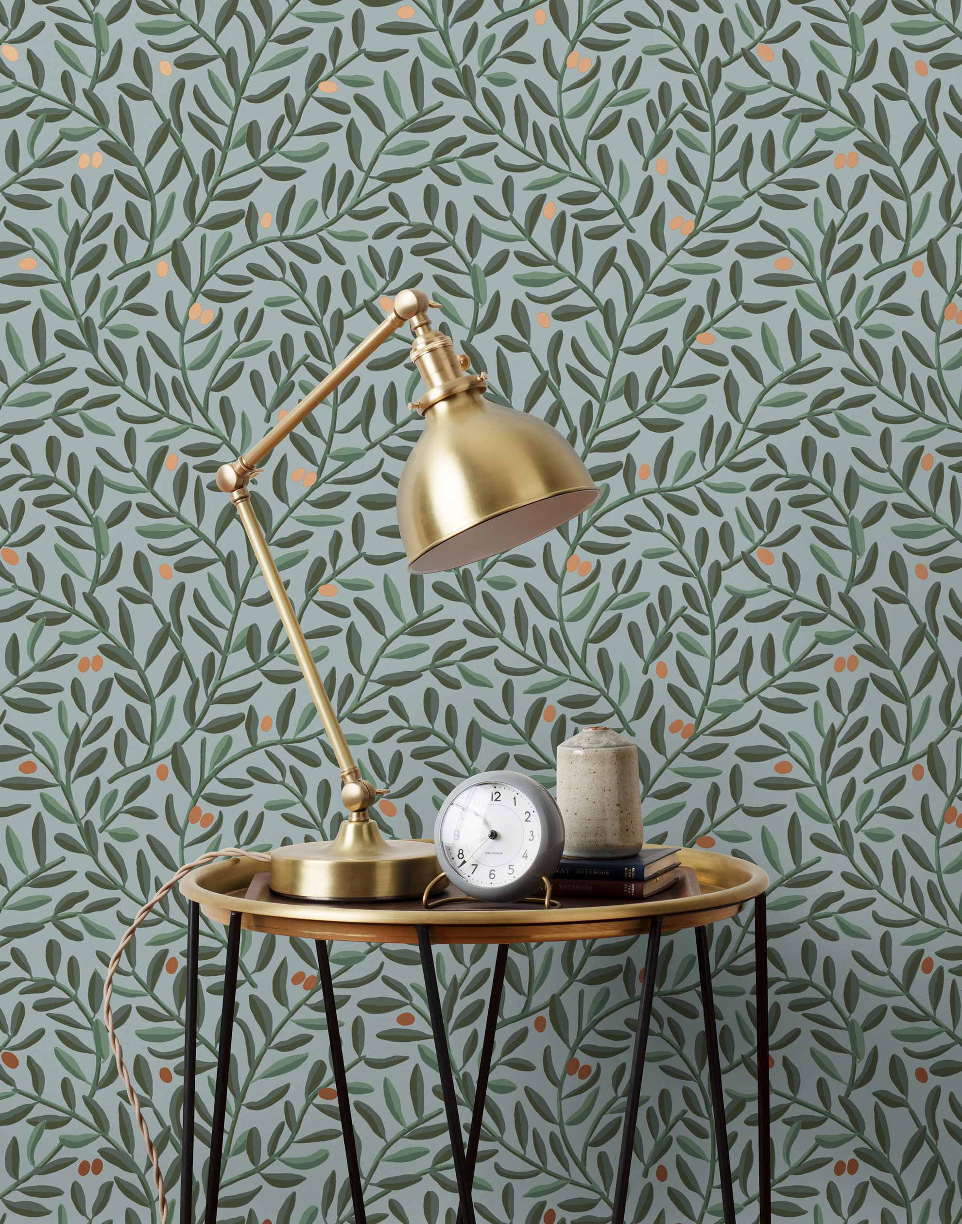 Olive Grove (Mist) featuring a leafy vine motif in shades of green with copper accents on dusty blue background | Schoolhouse x Hygge & West Wallpaper Collection