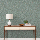 Olive Grove (Mist) featuring a leafy vine motif in shades of green with copper accents on dusty blue background | Schoolhouse x Hygge & West Wallpaper Collection