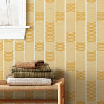 Wallpaper with undulating mustard yellow lines that form rhythmic columns on a white background | Schoolhouse + Hygge & West