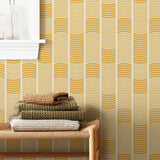 Wallpaper with undulating mustard yellow lines that form rhythmic columns on a white background | Schoolhouse + Hygge & West