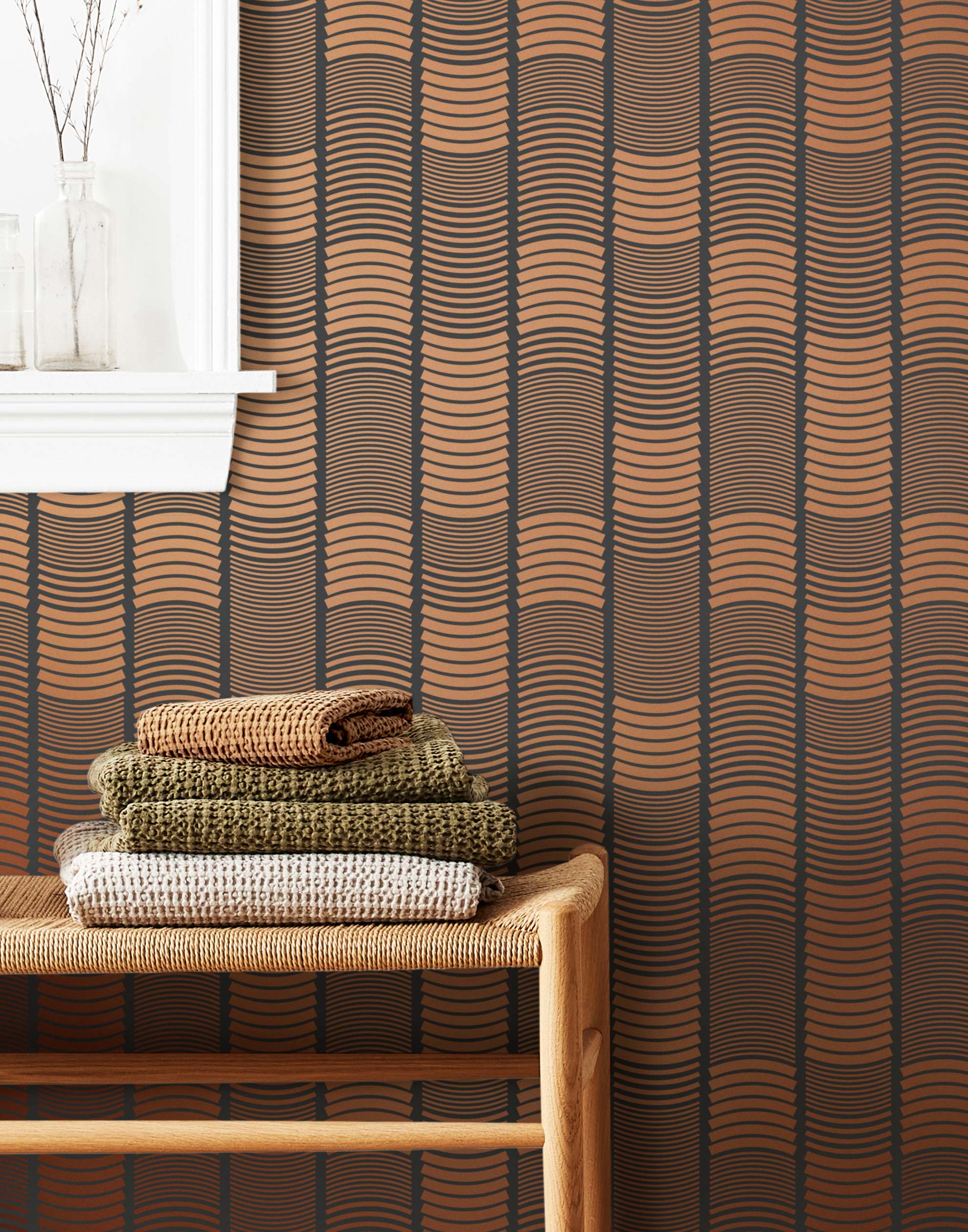 Wallpaper with undulating copper lines that form rhythmic columns on a dark gray background | Schoolhouse + Hygge & West