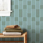 Wallpaper with undulating green lines that form rhythmic columns on a blue background | Schoolhouse + Hygge & West