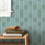 Wallpaper with undulating green lines that form rhythmic columns on a blue background | Schoolhouse + Hygge & West