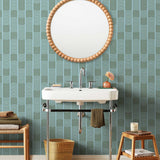 Wallpaper with undulating green lines that form rhythmic columns on a blue background | Schoolhouse + Hygge & West