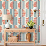 Wallpaper with irregular line work that weaves blue rectangles and red semicircles on an off white background | Schoolhouse + Hygge & West