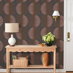 Wallpaper with irregular line work that weaves copper rectangles and pink semicircles on a deep gray background | Schoolhouse + Hygge & West