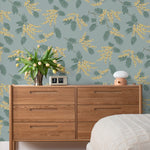 Wallpaper with yellow acacia flowers and green leaves on a dusty blue background | Schoolhouse + Hygge & West