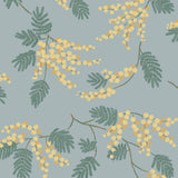 Wallpaper with yellow acacia flowers and green leaves on a dusty blue background | Schoolhouse + Hygge & West