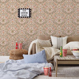 Inspired by the painted ceiling of Glinda and Elphaba's Shiz University dorm room in the movie Wicked, this wallpaper features colorful flowers and a crown on a soft pink background.