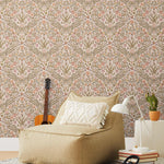 Inspired by the painted ceiling of Glinda and Elphaba's Shiz University dorm room in the movie Wicked, this wallpaper features colorful flowers and a crown on a soft pink background.