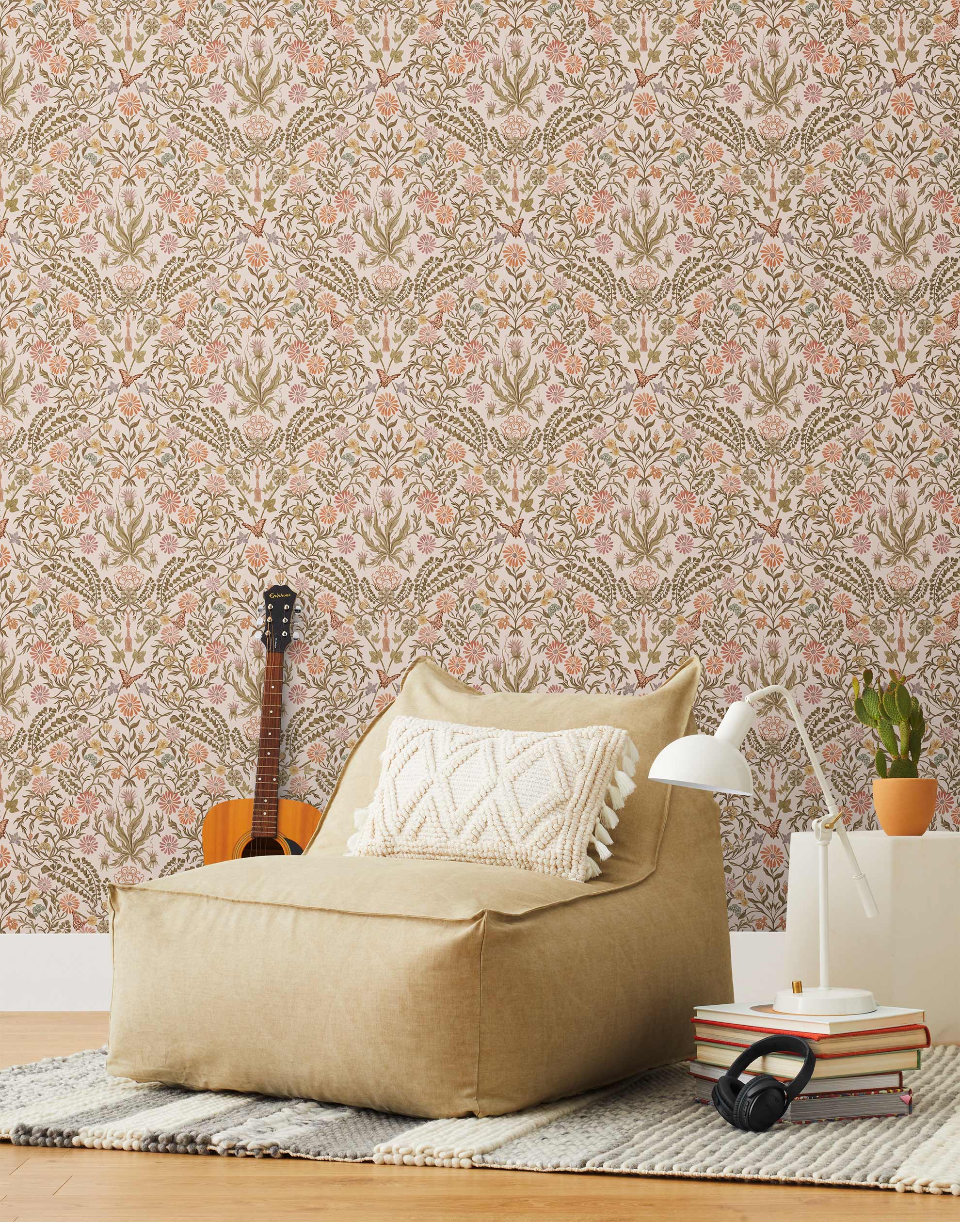 Inspired by the painted ceiling of Glinda and Elphaba's Shiz University dorm room in the movie Wicked, this wallpaper features colorful flowers and a crown on a soft pink background.
