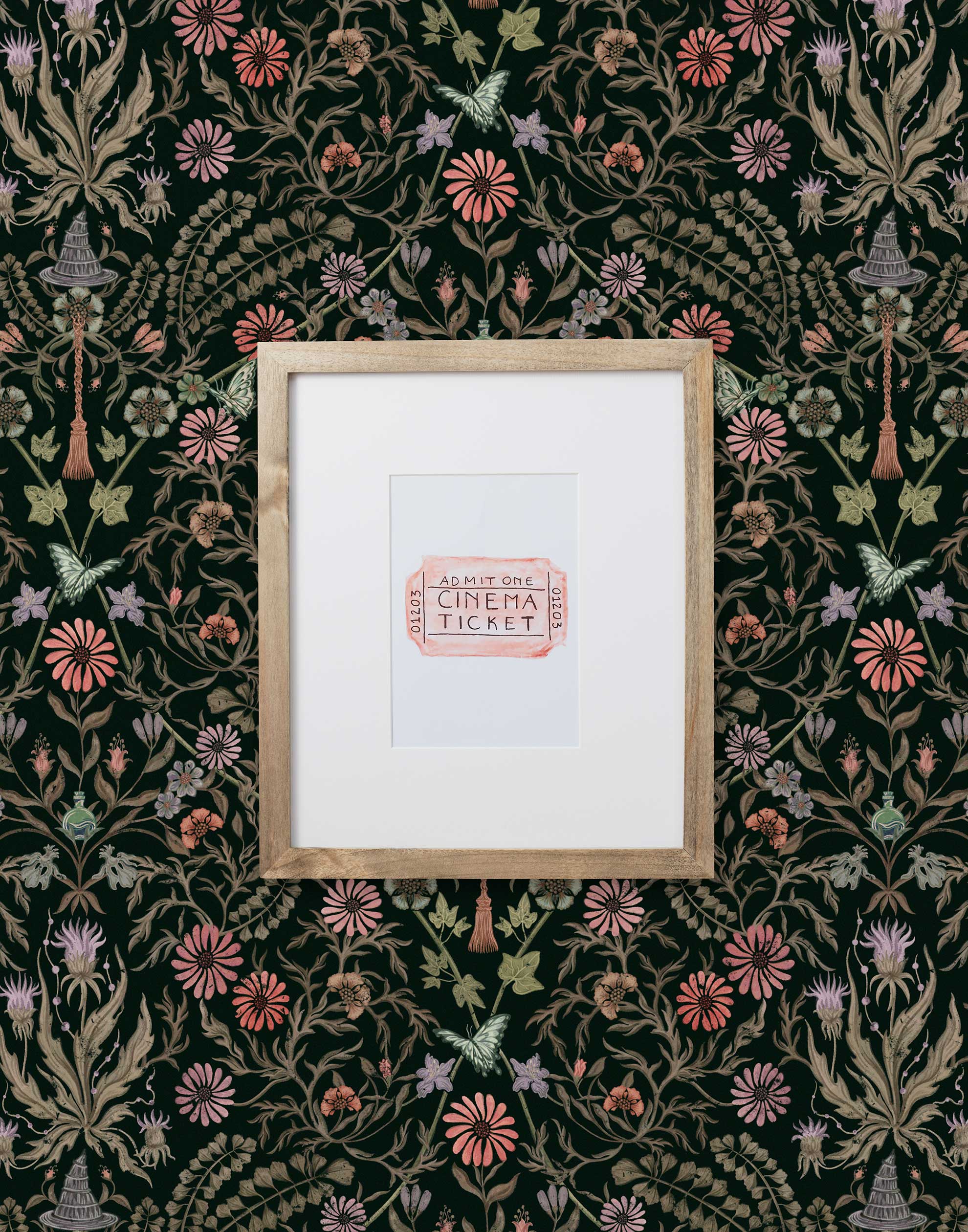 Inspired by the painted ceiling of Glinda and Elphaba's Shiz University dorm room in the movie Wicked, this wallpaper features colorful flowers and a witch's hat and broom on a dark green background.