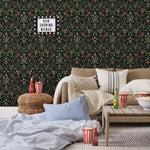Inspired by the painted ceiling of Glinda and Elphaba's Shiz University dorm room in the movie Wicked, this wallpaper features colorful flowers and a witch's hat and broom on a dark green background.