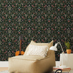 Inspired by the painted ceiling of Glinda and Elphaba's Shiz University dorm room in the movie Wicked, this wallpaper features colorful flowers and a witch's hat and broom on a dark green background.