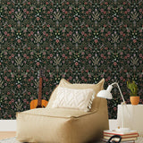 Inspired by the painted ceiling of Glinda and Elphaba's Shiz University dorm room in the movie Wicked, this wallpaper features colorful flowers and a witch's hat and broom on a dark green background.
