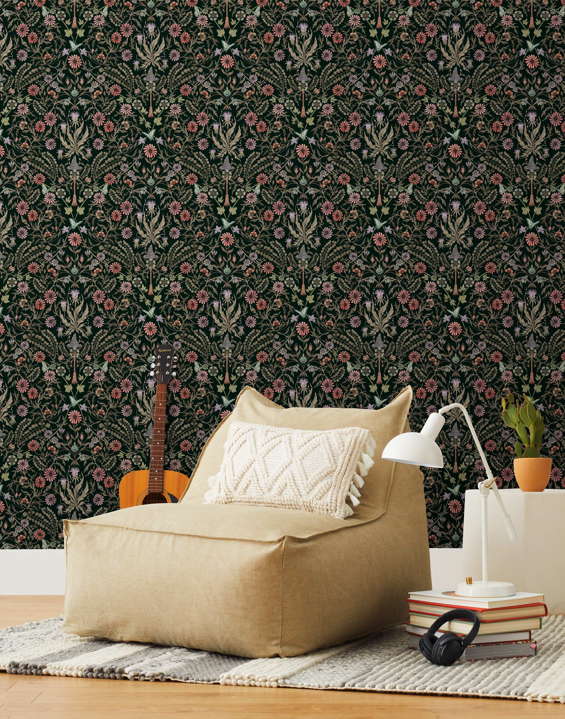Inspired by the painted ceiling of Glinda and Elphaba's Shiz University dorm room in the movie Wicked, this wallpaper features colorful flowers and a witch's hat and broom on a dark green background.