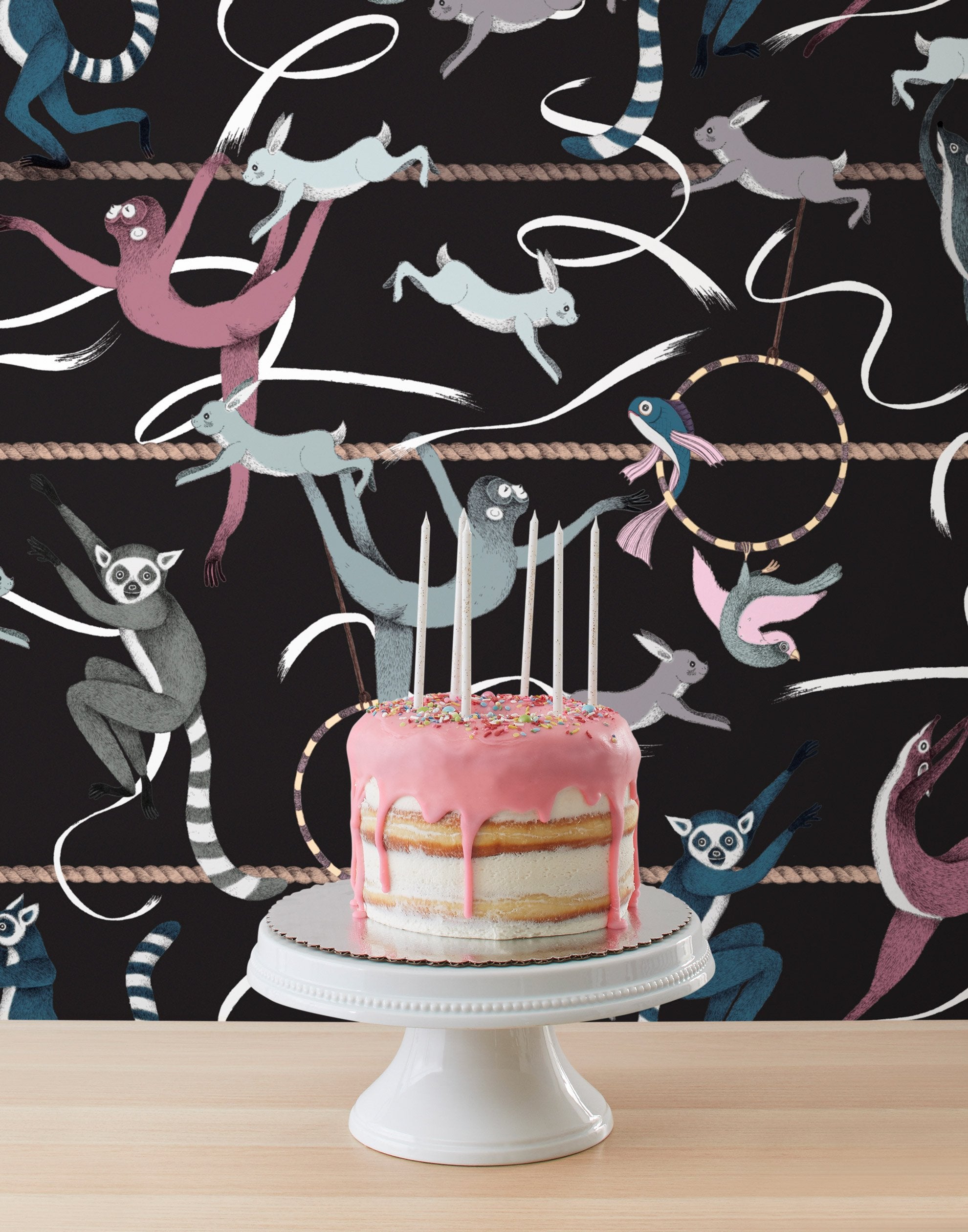 Balancing Act (Ebony) wallpaper features colorful dancing monkeys and rabbits on a black background