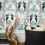 Mermaids (Ocean) wallpaper | Mermaids, fish, octopi and ships float in this charming design | turquoise and black artwork on an off white ground