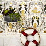 Mermaids (Gold) wallpaper | Mermaids, fish, octopi and ships float in this charming design | Gold and black artwork on an off white ground