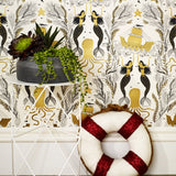 Mermaids (Gold) wallpaper | Mermaids, fish, octopi and ships float in this charming design | Gold and black artwork on an off white ground
