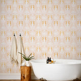 Mermaids (Shell Pink) wallpaper | Mermaids, fish, octopi and ships float in this charming design | Gold and white artwork on a pink ground