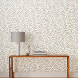 Bloom (Taupe) Wallpaper featuring light gray dots and taupe stems on an off white ground in a modern, graphic floral