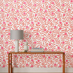 Bloom (Poppy) Wallpaper featuring pink dots and coral orange stems on a white ground in a modern, graphic floral 