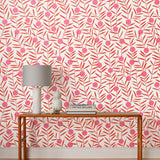 Bloom (Poppy) Wallpaper featuring pink dots and coral orange stems on a white ground in a modern, graphic floral 