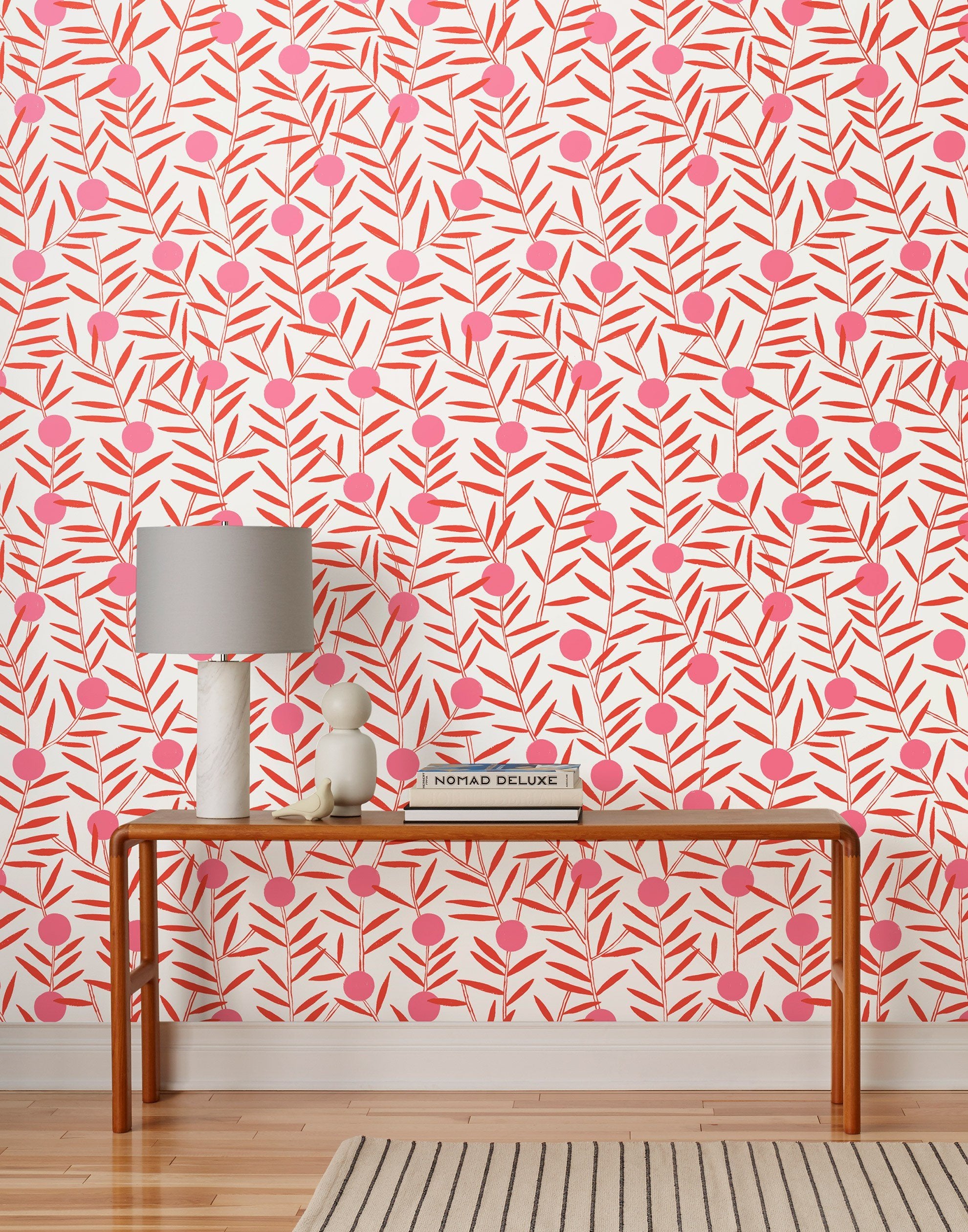 Bloom (Poppy) Wallpaper featuring pink dots and coral orange stems on a white ground in a modern, graphic floral 