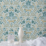 Piedmont (Mist) wallpaper with tan foxes, dusty deep green flora, cream accents on a light gray blue background
