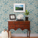 Piedmont (Mist) wallpaper with tan foxes, dusty deep green flora, cream accents on a light gray blue background