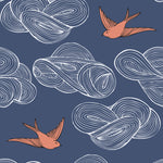 Daydream (Indigo) wallpaper features a pattern of flying birds and floating clouds in orange white and blue