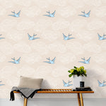 Daydream (Cream) features a pattern of flying birds and floating clouds in blue and white on cream