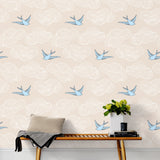 Daydream (Cream) features a pattern of flying birds and floating clouds in blue and white on cream