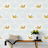 Daydream (Sunshine) features a pattern of flying birds and floating clouds in yellow and blue on white