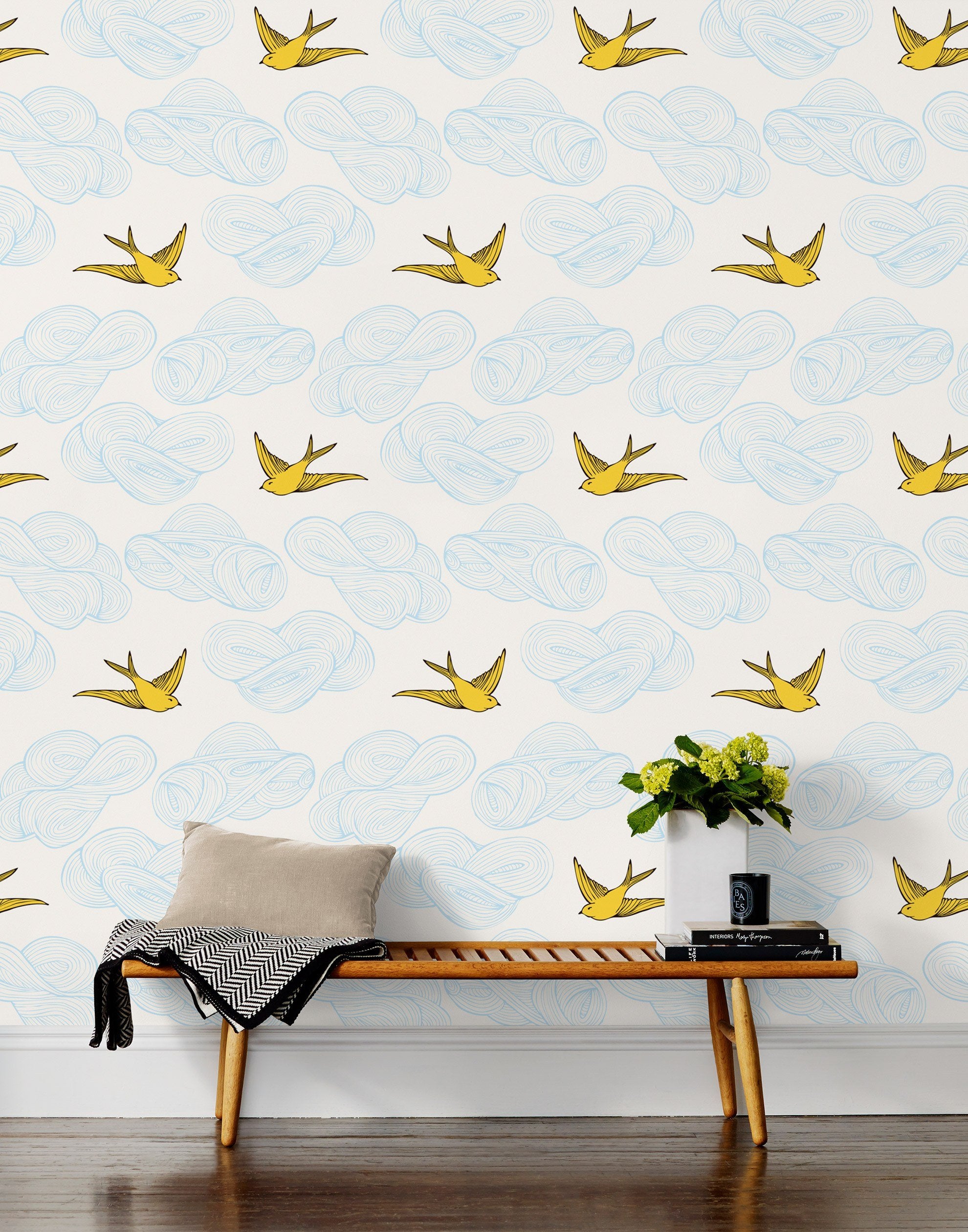 Daydream (Sunshine) features a pattern of flying birds and floating clouds in yellow and blue on white