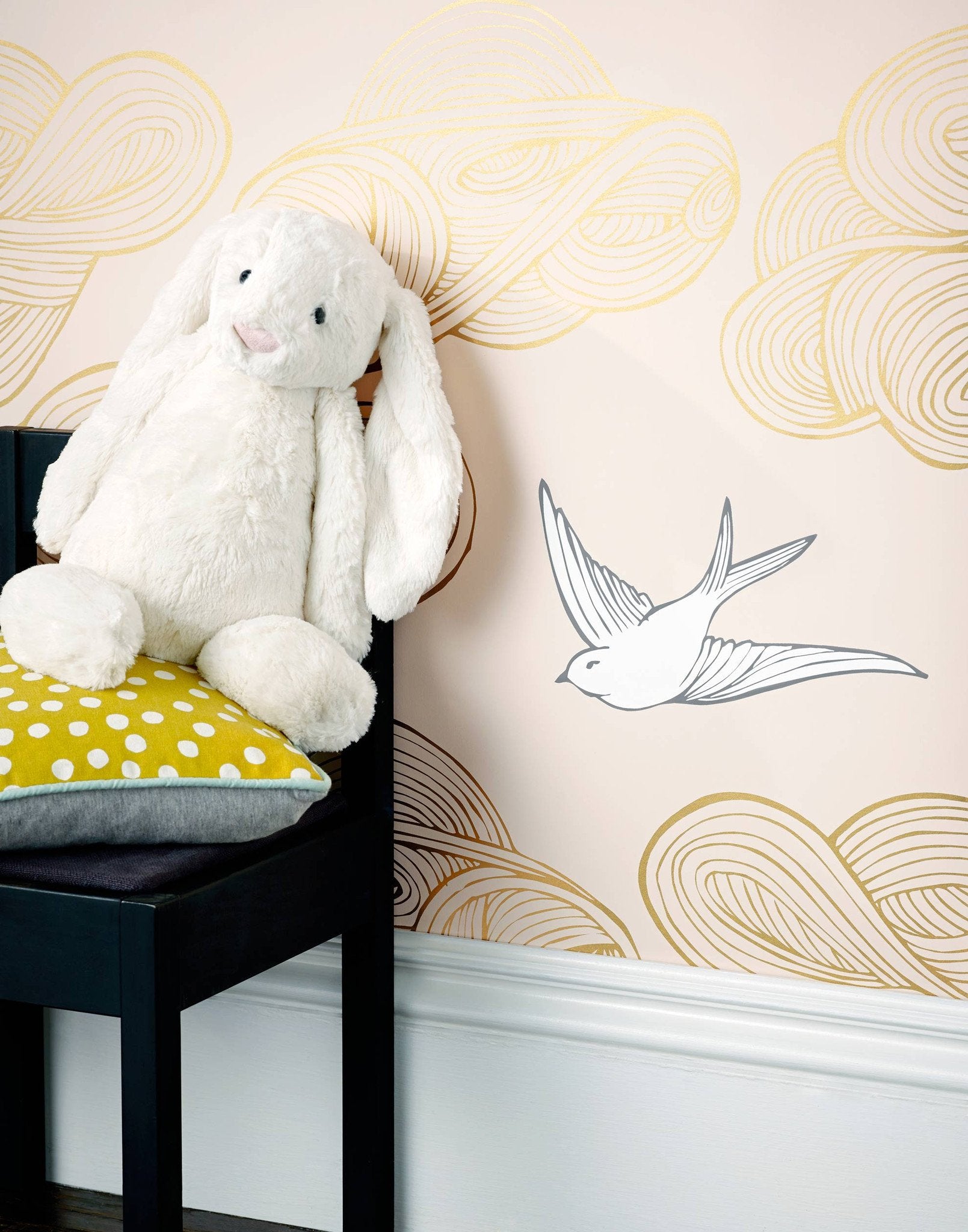 Daydream (Blush) features a pattern of flying birds and floating clouds in metallic gold and white on pink