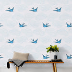 Daydream (French Blue) features a pattern of flying birds and floating clouds in shades of blue on white