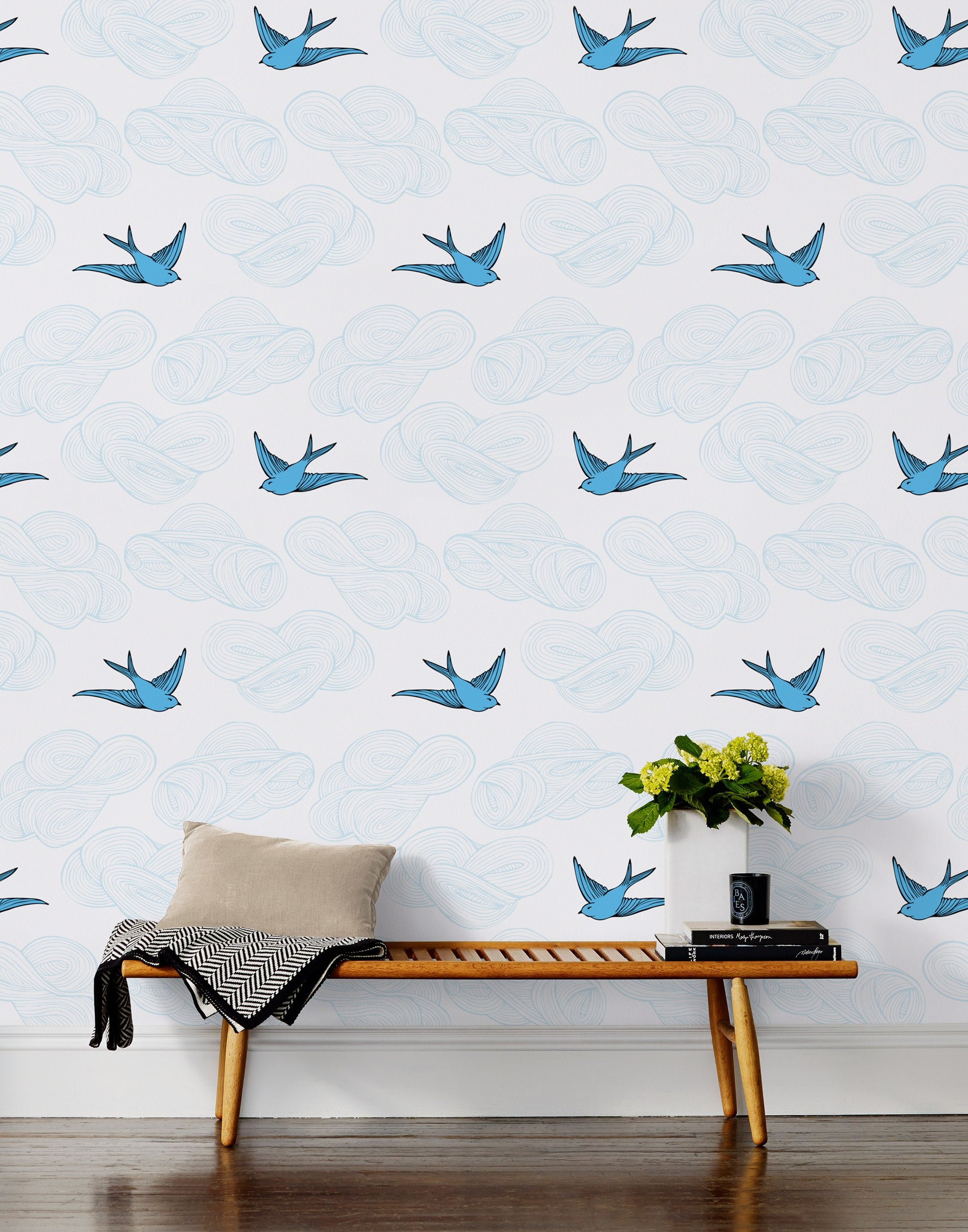 Daydream (French Blue) features a pattern of flying birds and floating clouds in shades of blue on white