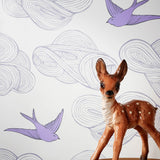 Daydream (Lilac) features a pattern of flying birds and floating clouds in purple and gray on white