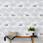 Daydream (Lilac) features a pattern of flying birds and floating clouds in purple and gray on white