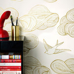 Daydream (Gold) features a pattern of flying birds and floating clouds in metallic on white