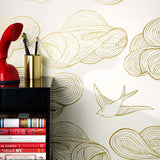 Daydream (Gold) features a pattern of flying birds and floating clouds in metallic on white