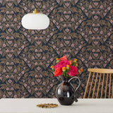 Symmetry wallpaper is a stylized floral wallpaper and designed in linocut style by Katharine Watson for Hygge & West | Metallic gold and pink flowers on a soft black wallpaper background.