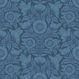 Conservatory wallpaper featuring stylized petals and leaves dervived from a block-print technique was designed by Katharine Watson for Hygge & West. Featuring cornflower blue flowers on a navy blue wallpaper background.