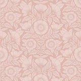 Conservatory wallpaper featuring stylized petals and leaves dervived from a block-print technique was designed by Katharine Watson for Hygge & West. Featuring light pink flowers on a rose pink wallpaper background.